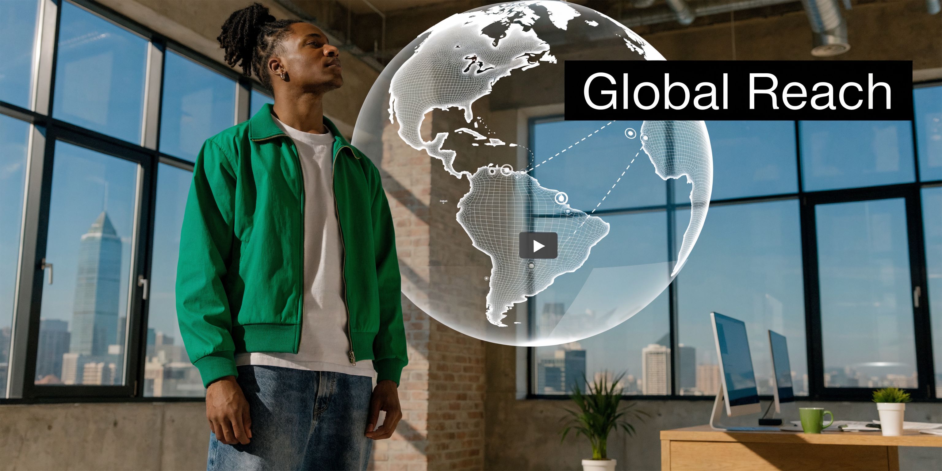 A young man in a green jacket looking at a digital hologram of a rotating globe in an office.