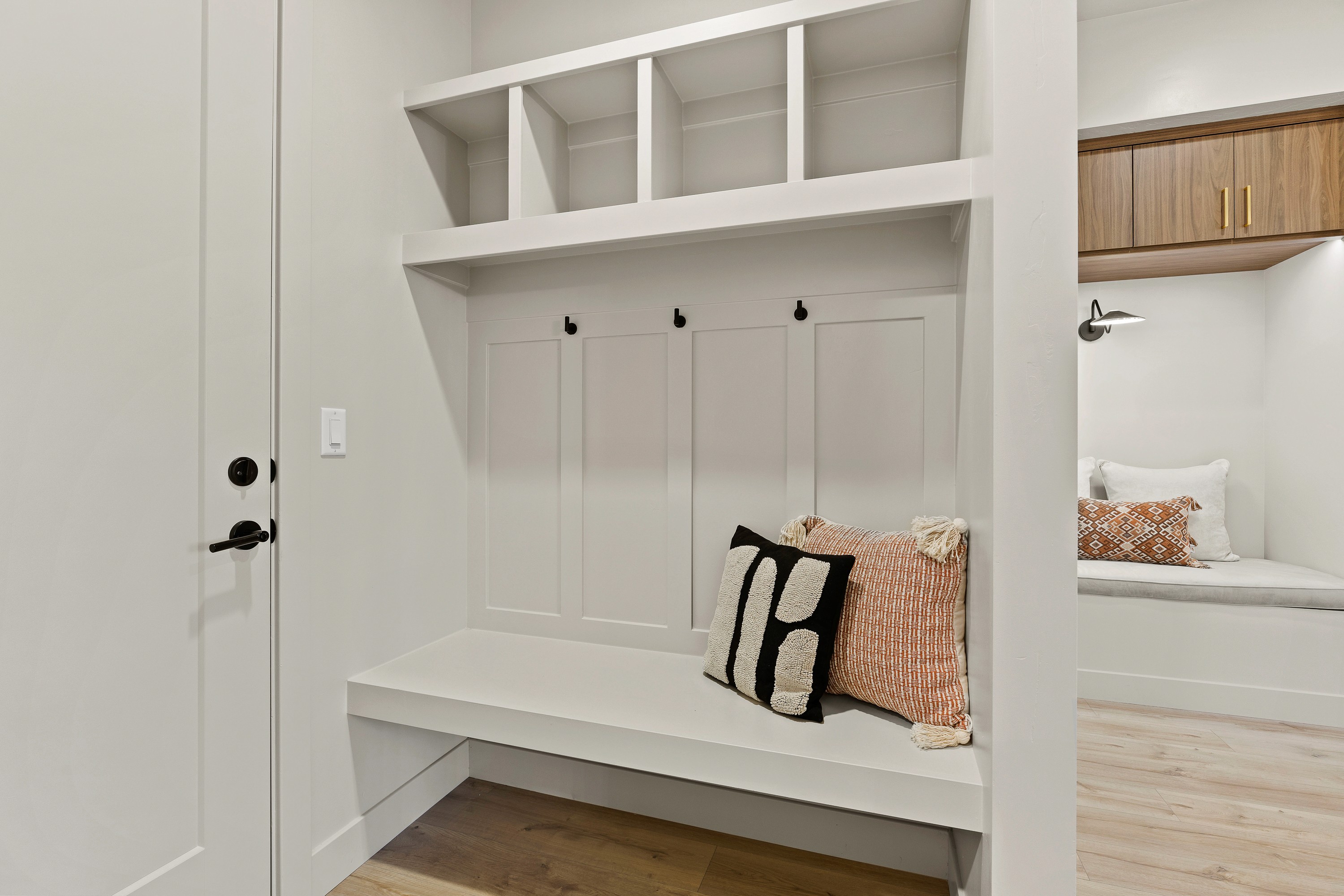 Mudroom bench by the garage entry in The Painted Horizon twin home in Hurricane, Utah with built-in seating and storage.