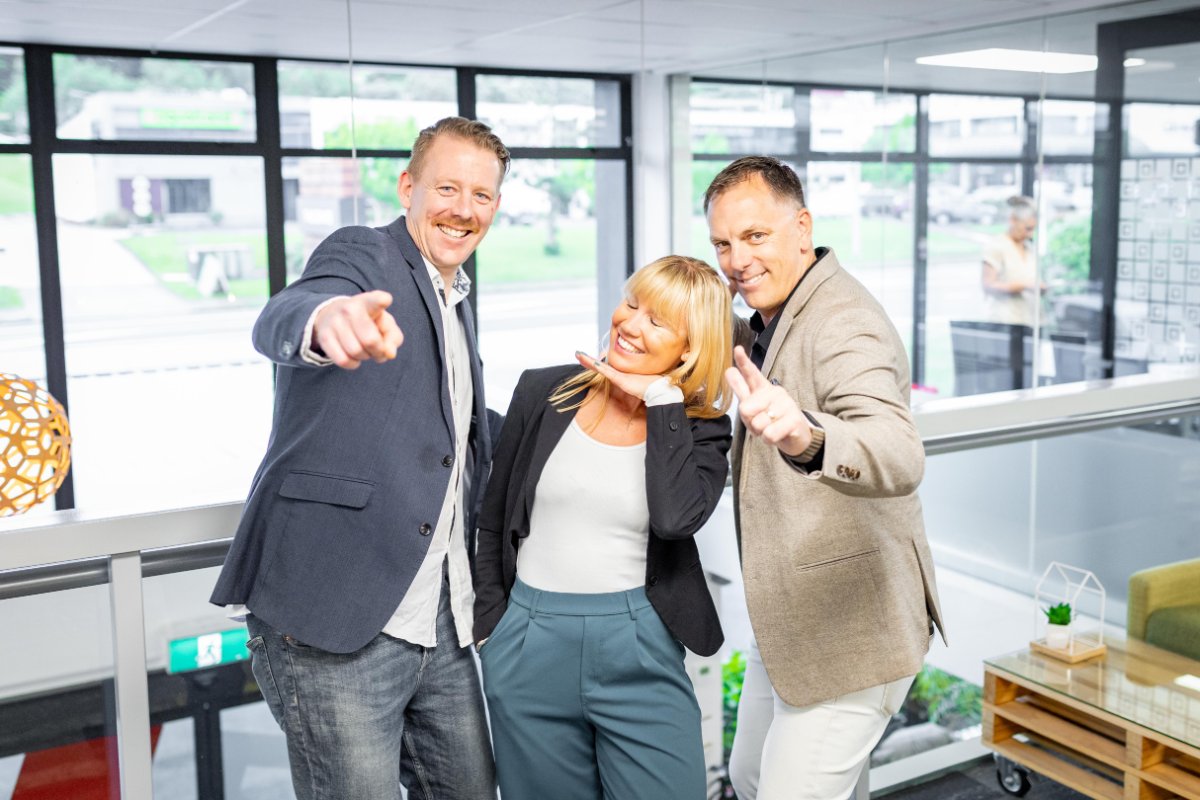 Three staff members at The Crate Albany-Rosedale laughing and pointing toward the camera.