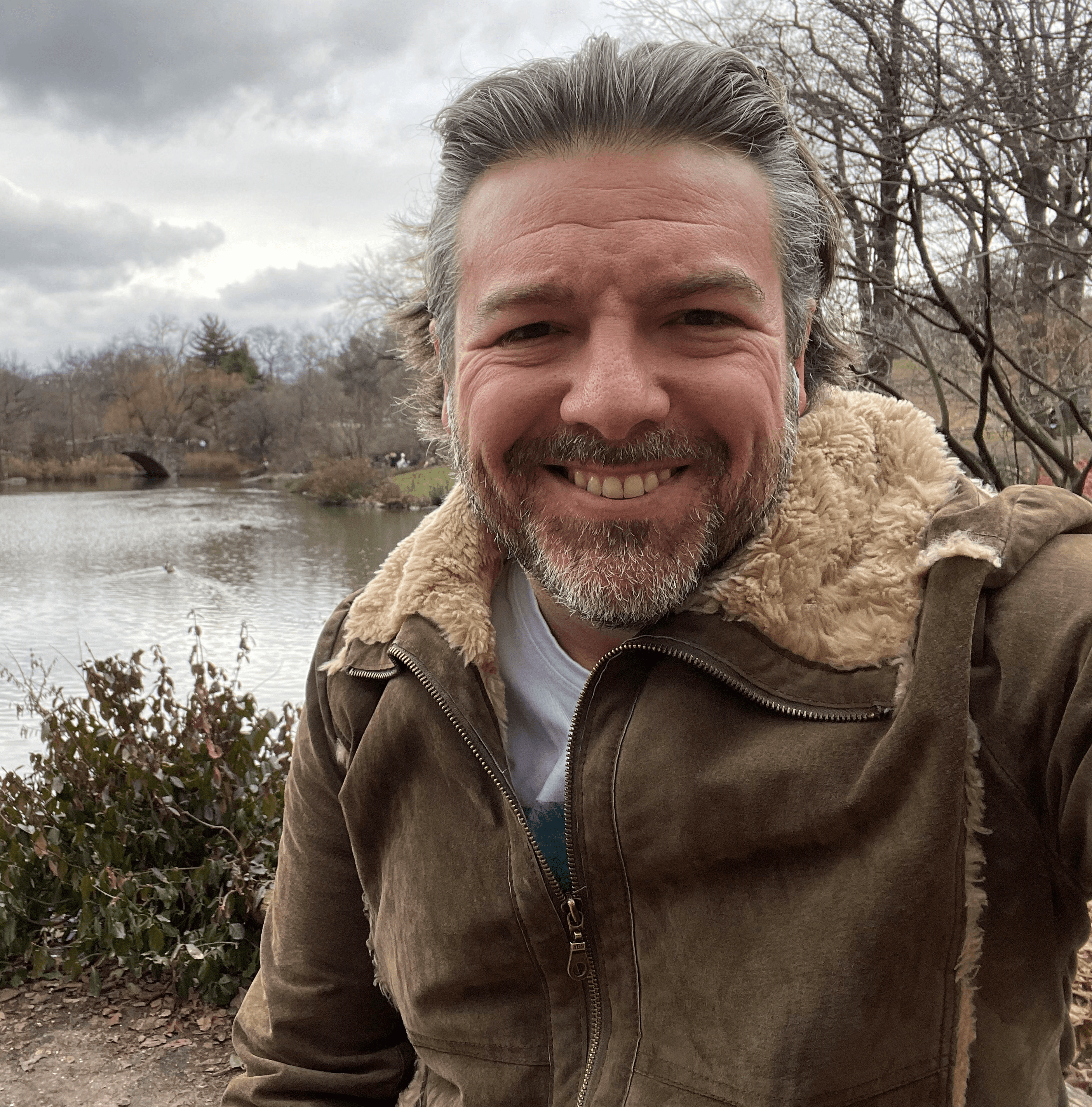 Man by lake in Central Park, NY