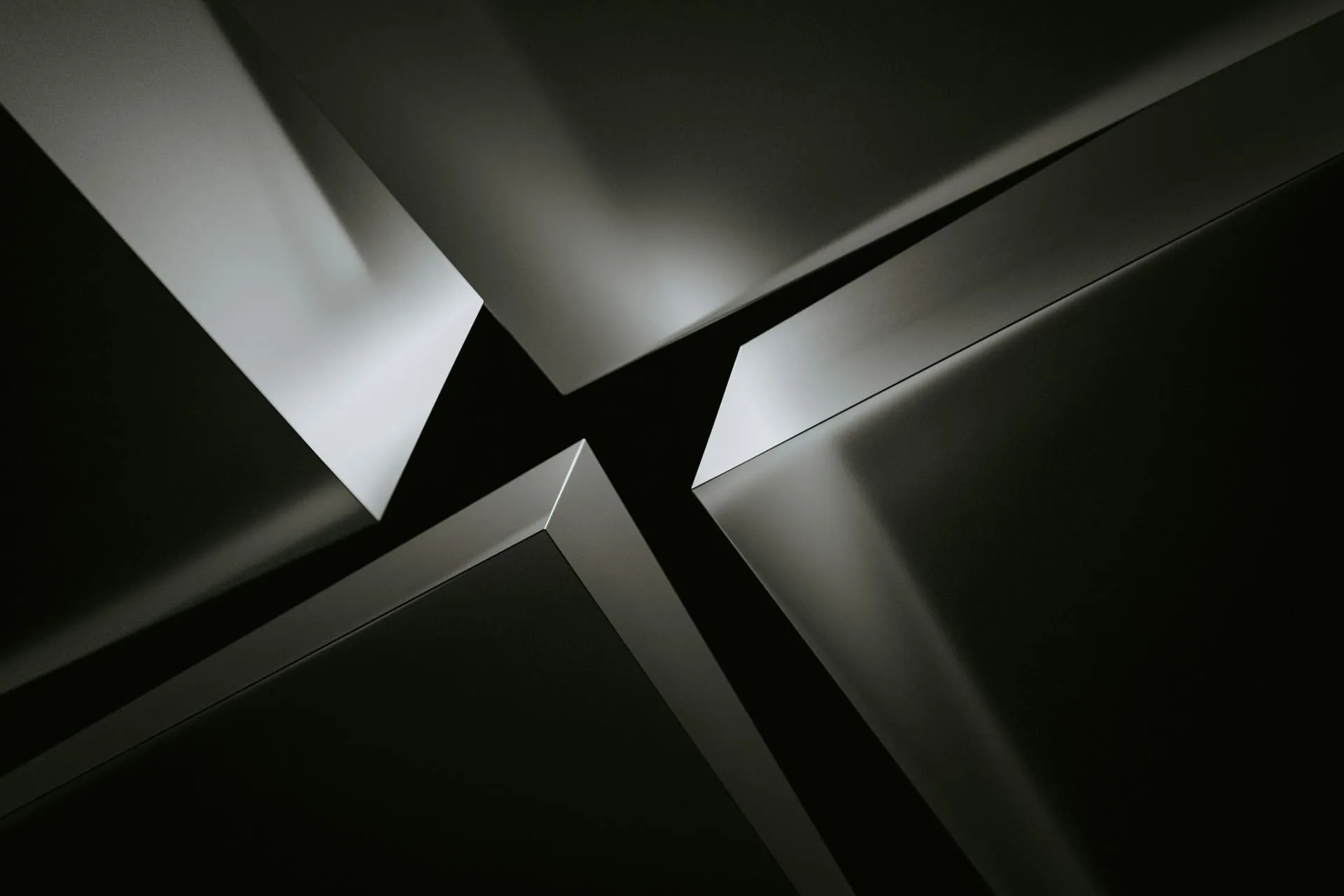 High-contrast grayscale abstract of intersecting sharp geometric forms.