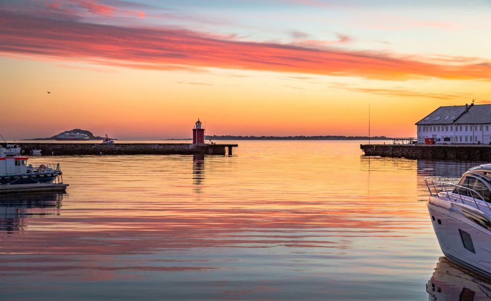 man wearing gray polo shirt beside dry-erase board