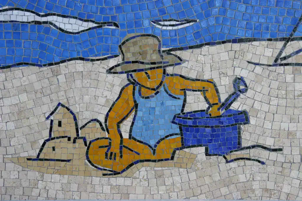 Mosaic mural depicting a child playing on the beach, part of the San Diego Airport Ode to the Pacifi.