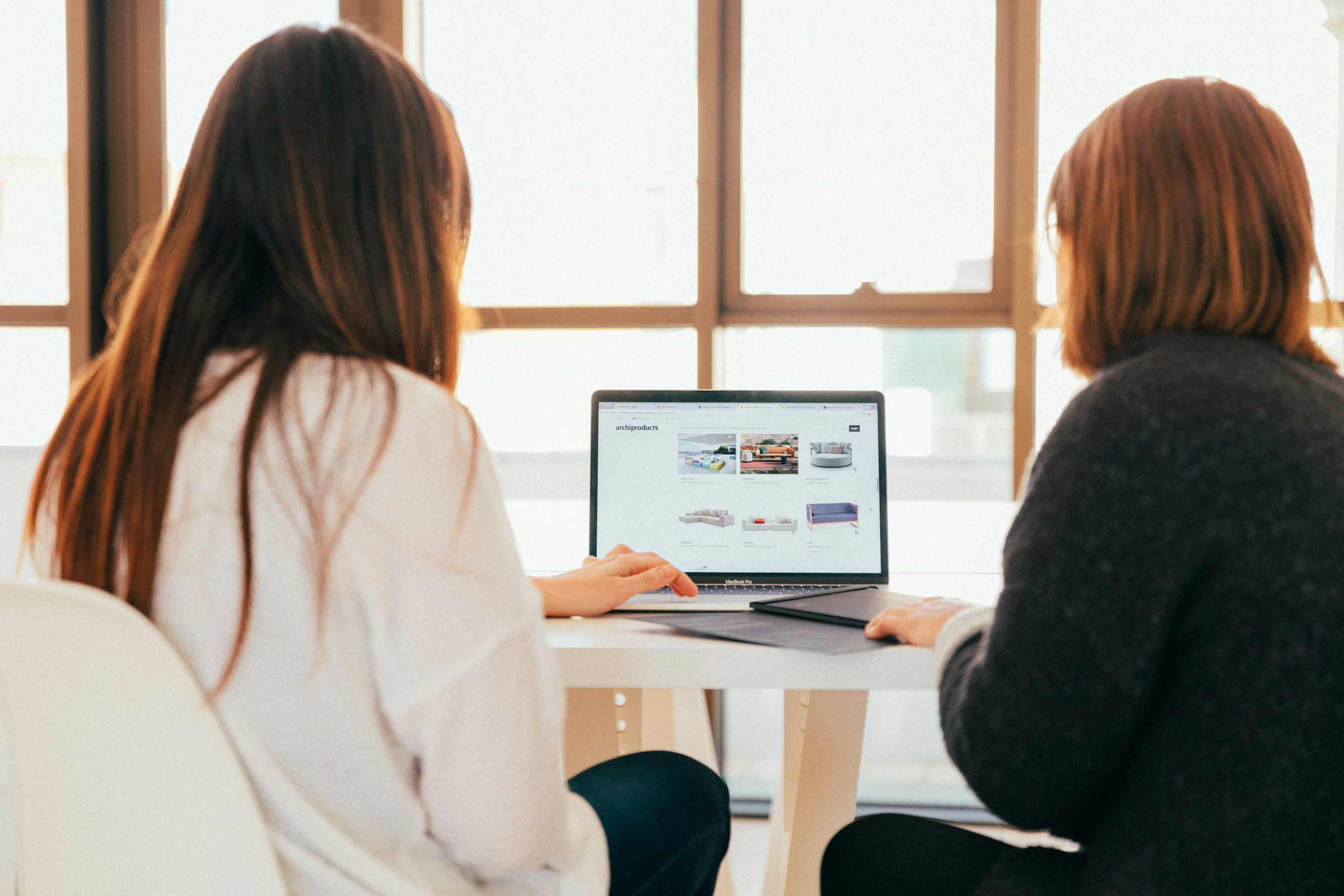 person with a friend infront of a laptop - Shopify Product Page Examples