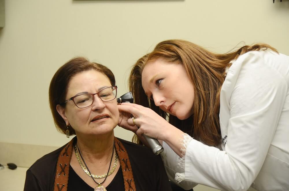 Man sitting in a testing booth having a hearing test