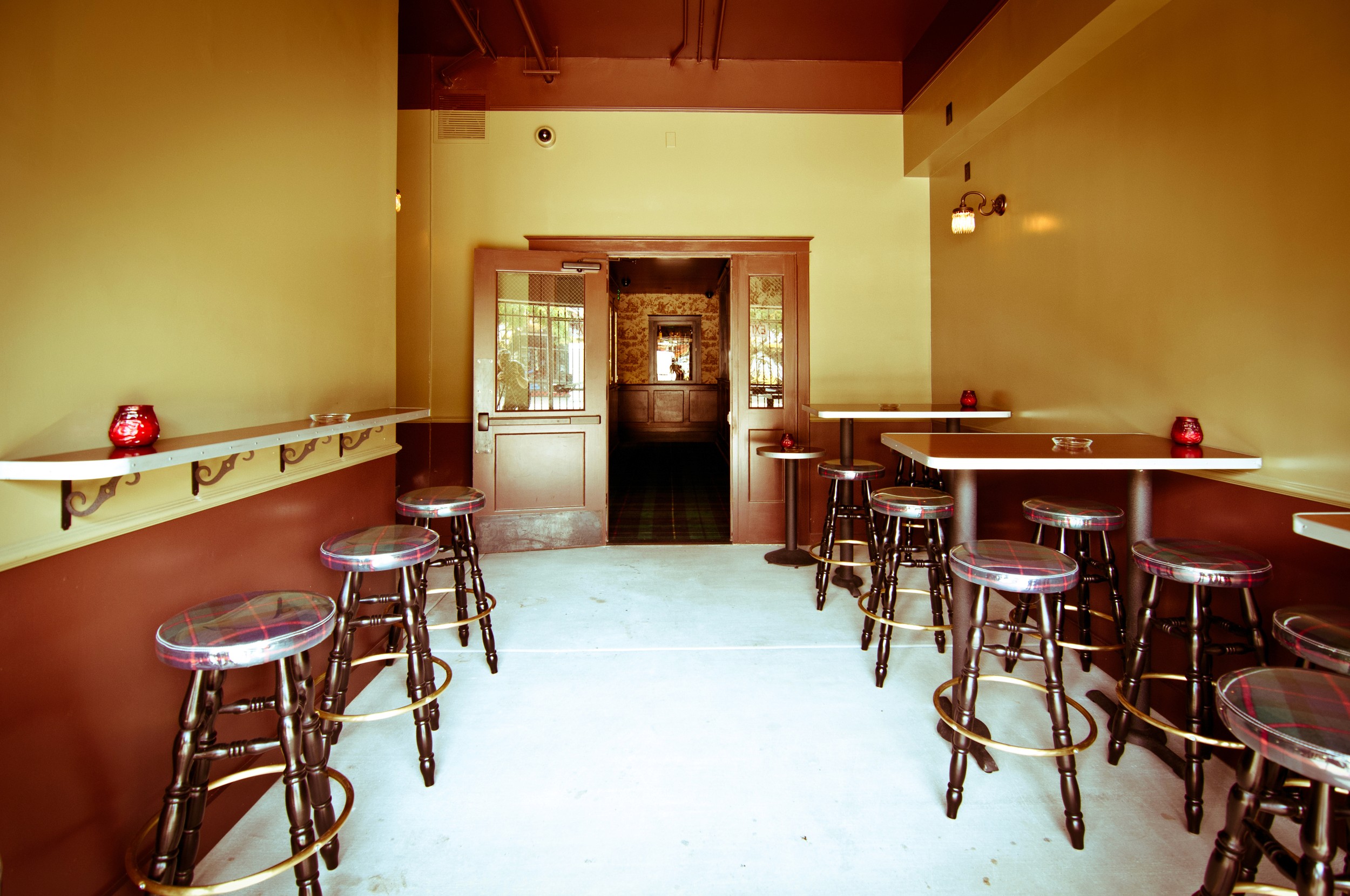Bar Three Piece entry room with stools, tables and doors to the back bar