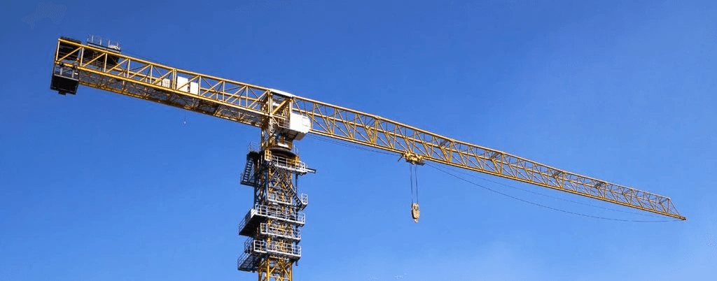 a yellow tower crane with blue skies