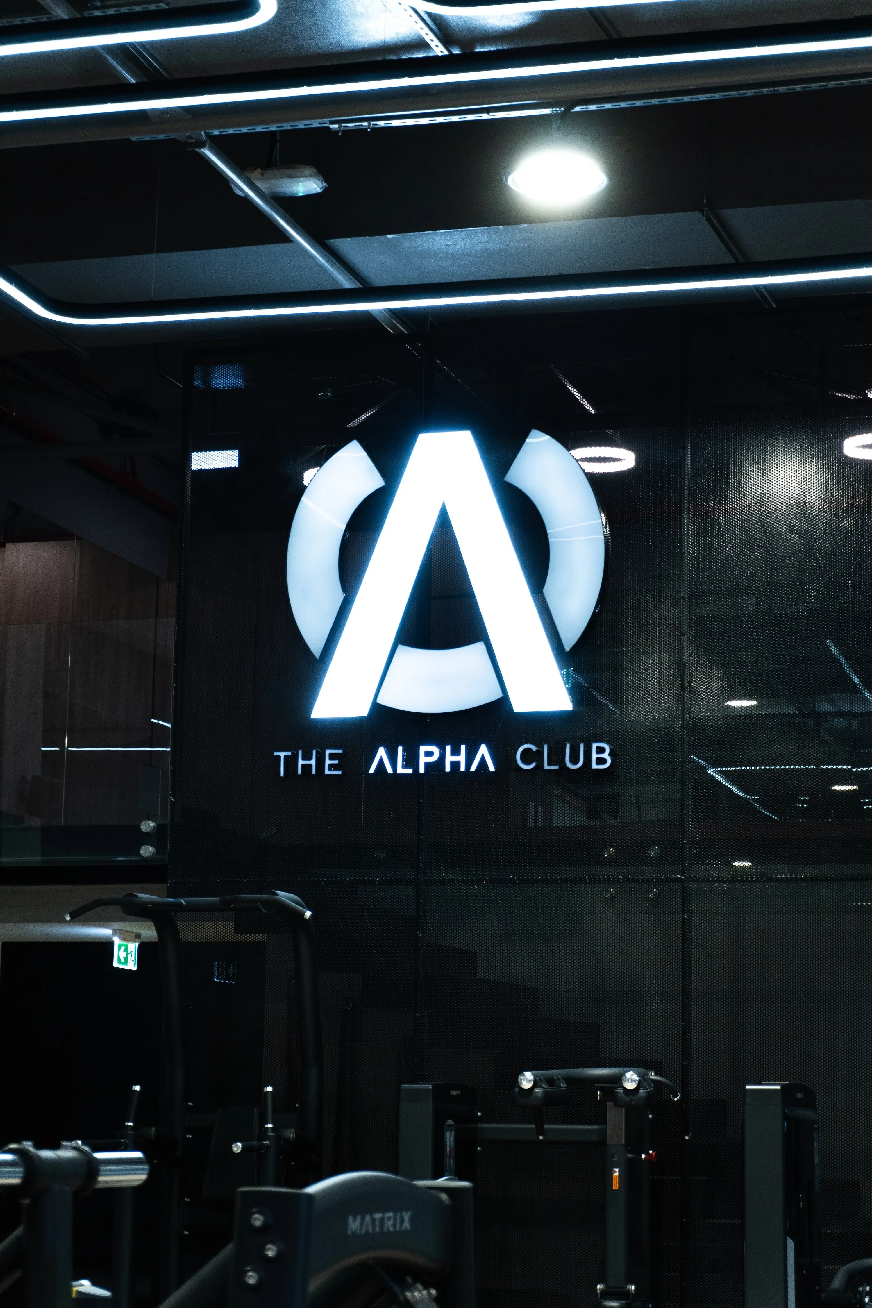 he Alpha Club illuminated logo sign inside the gym.