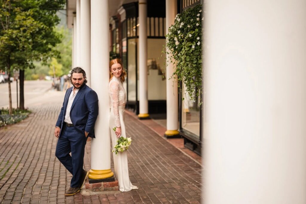 Bride and groom standing outside a historic building in Aspen