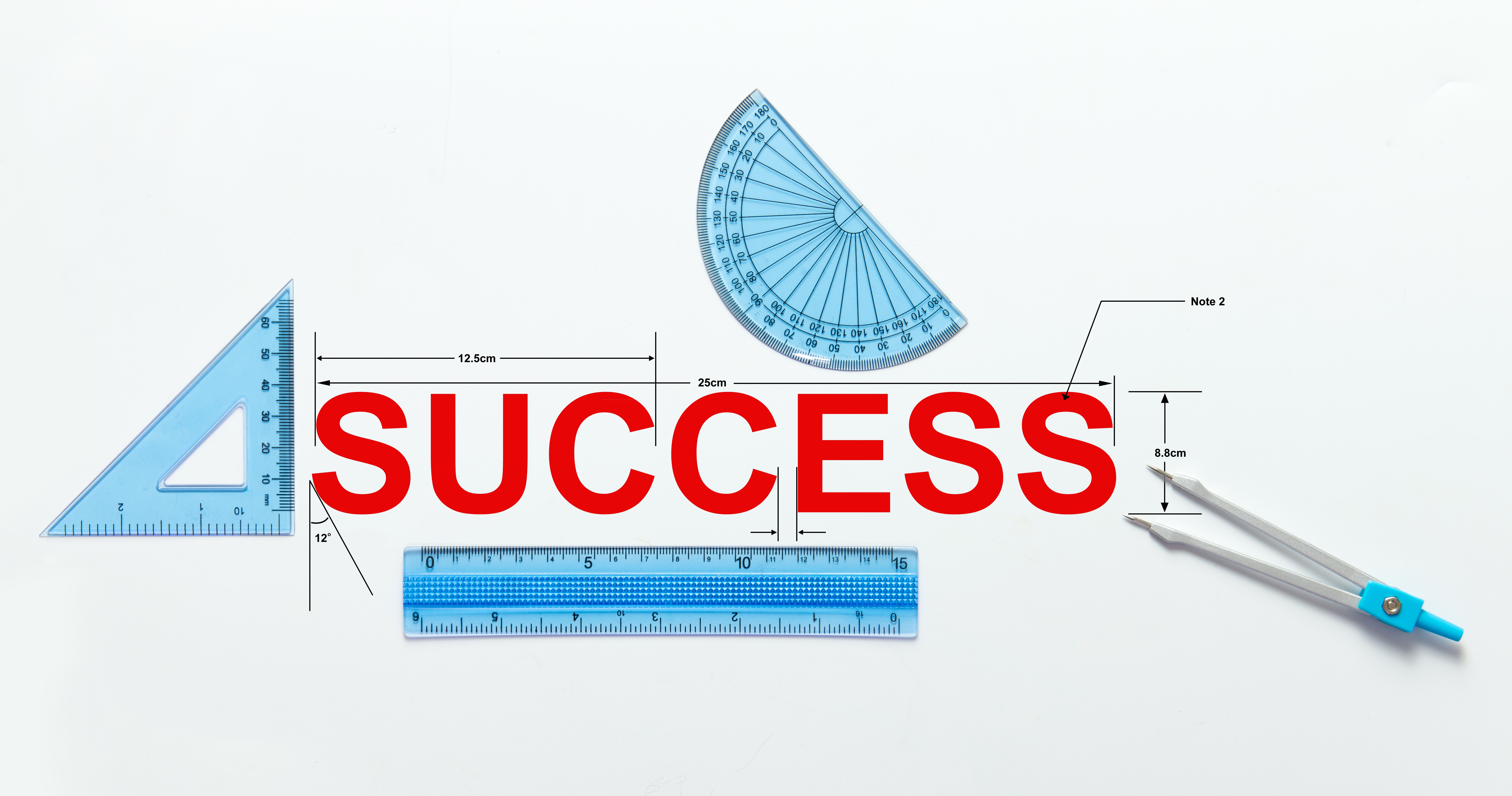 SUCCESS surrounded by blue measuring tools, including a triangle, ruler, protractor, and compass, symbolizing precision and planning.