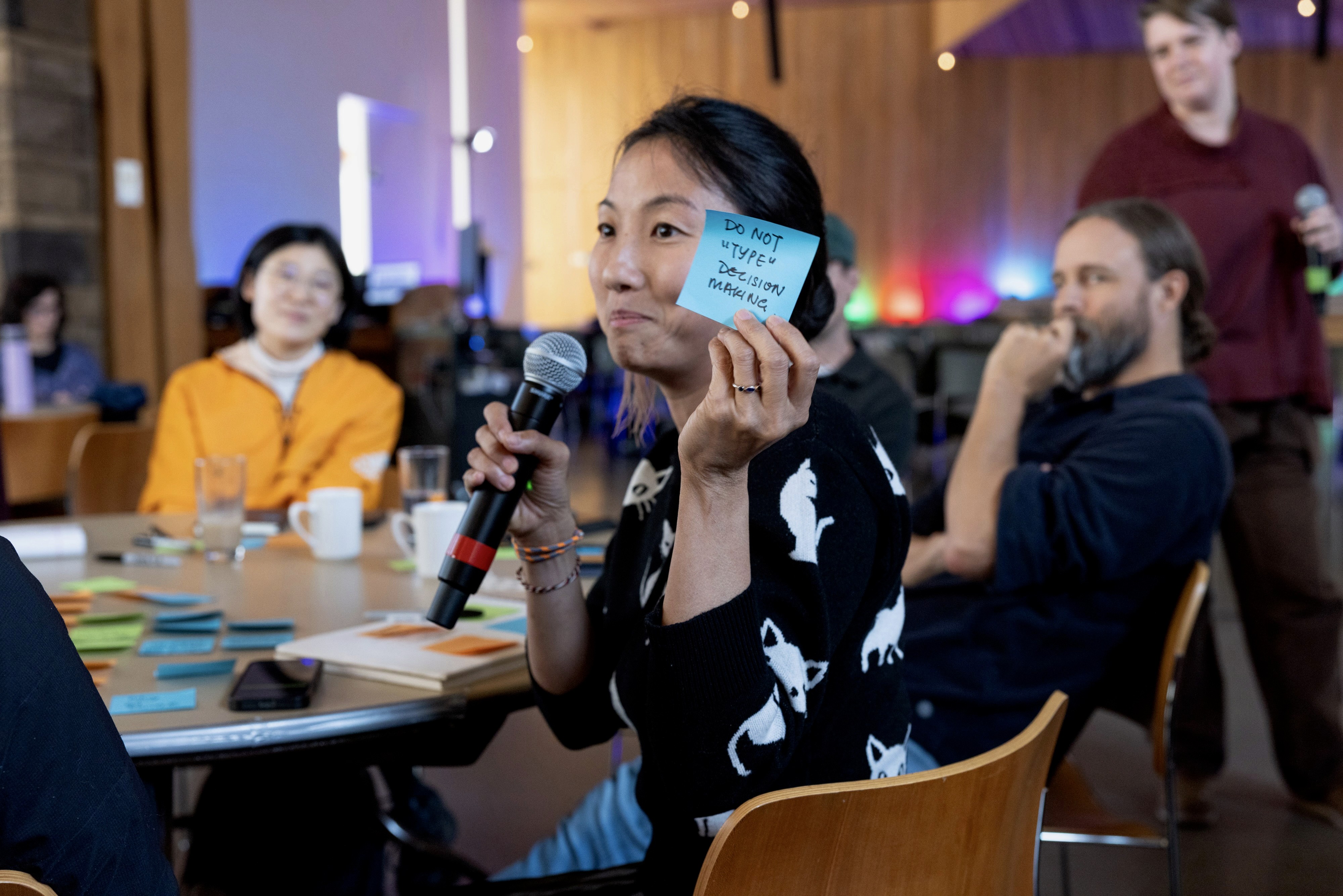 A woman asking a question during a design thinking exercise at the Artificiality Summit