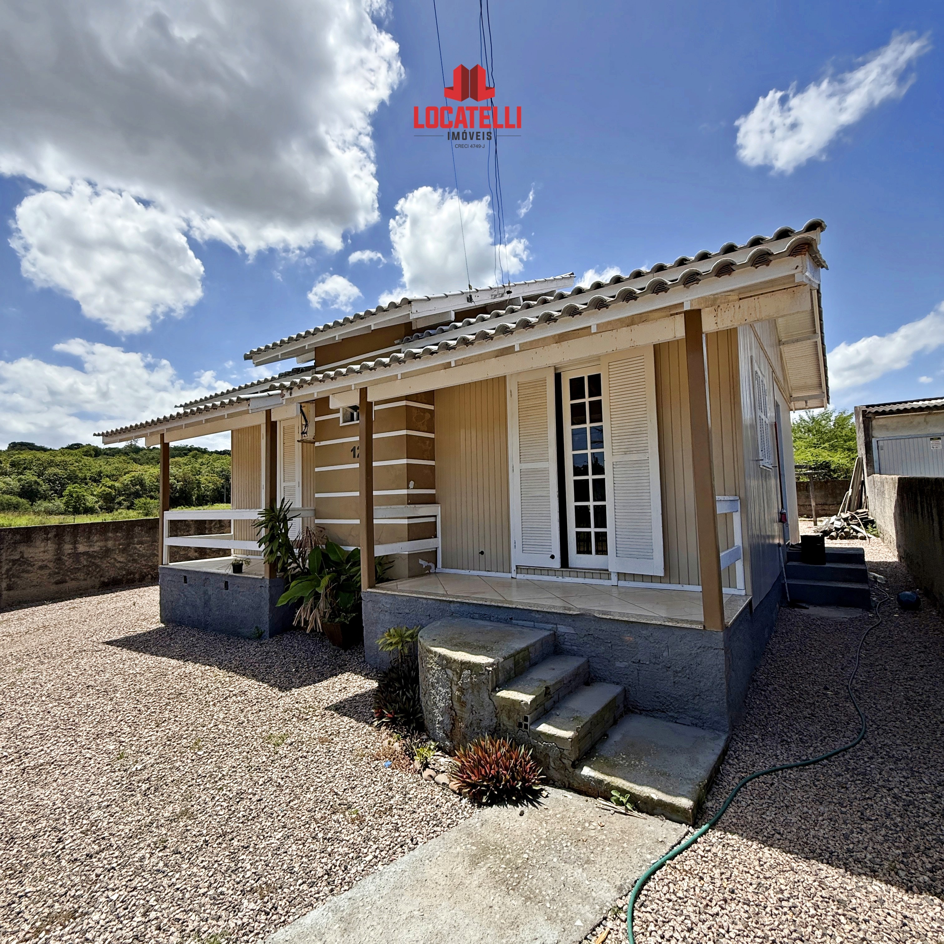 A modern brick house with a two-car garage, well-manicured lawn, and clear blue sky in the background.