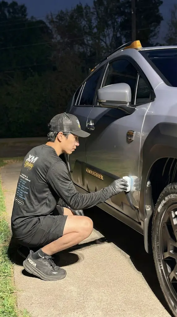 Professional mobile car detailing in Houston featuring a lime green Lamborghini Revuelto with a ceramic coating finish parked outside a detailing studio.