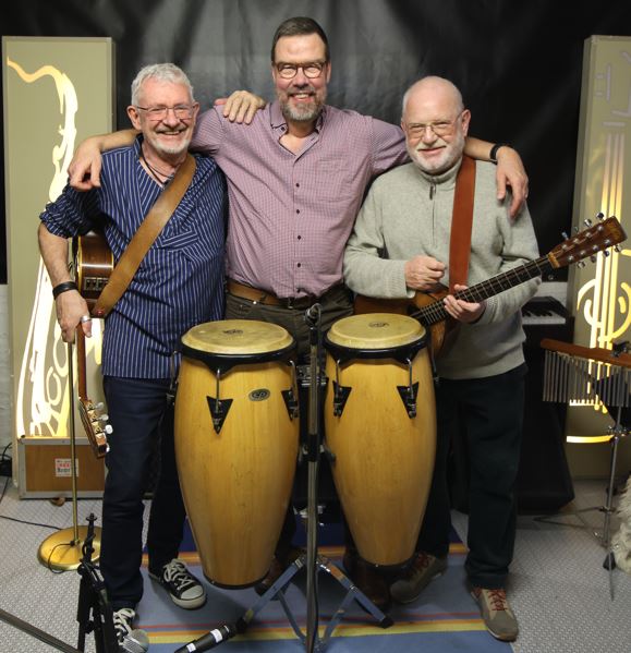 Group photo of the three band members with their instruments.