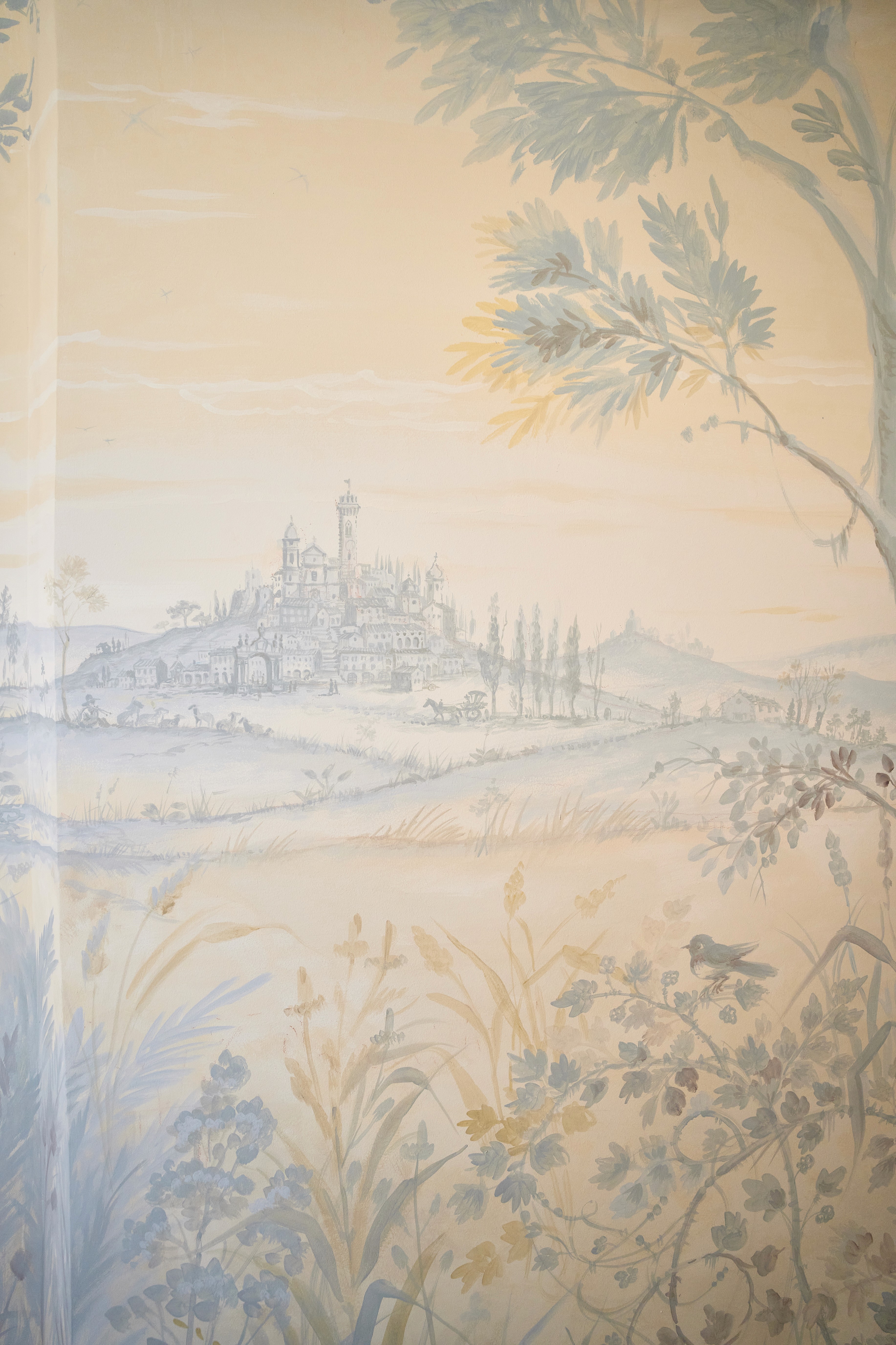 A serene and elegant spa space with wooden reclining chairs and white cushions. Golden sunlight filters through a cascading water feature, creating a peaceful atmosphere. Tropical plants and candles add to the relaxing ambiance.