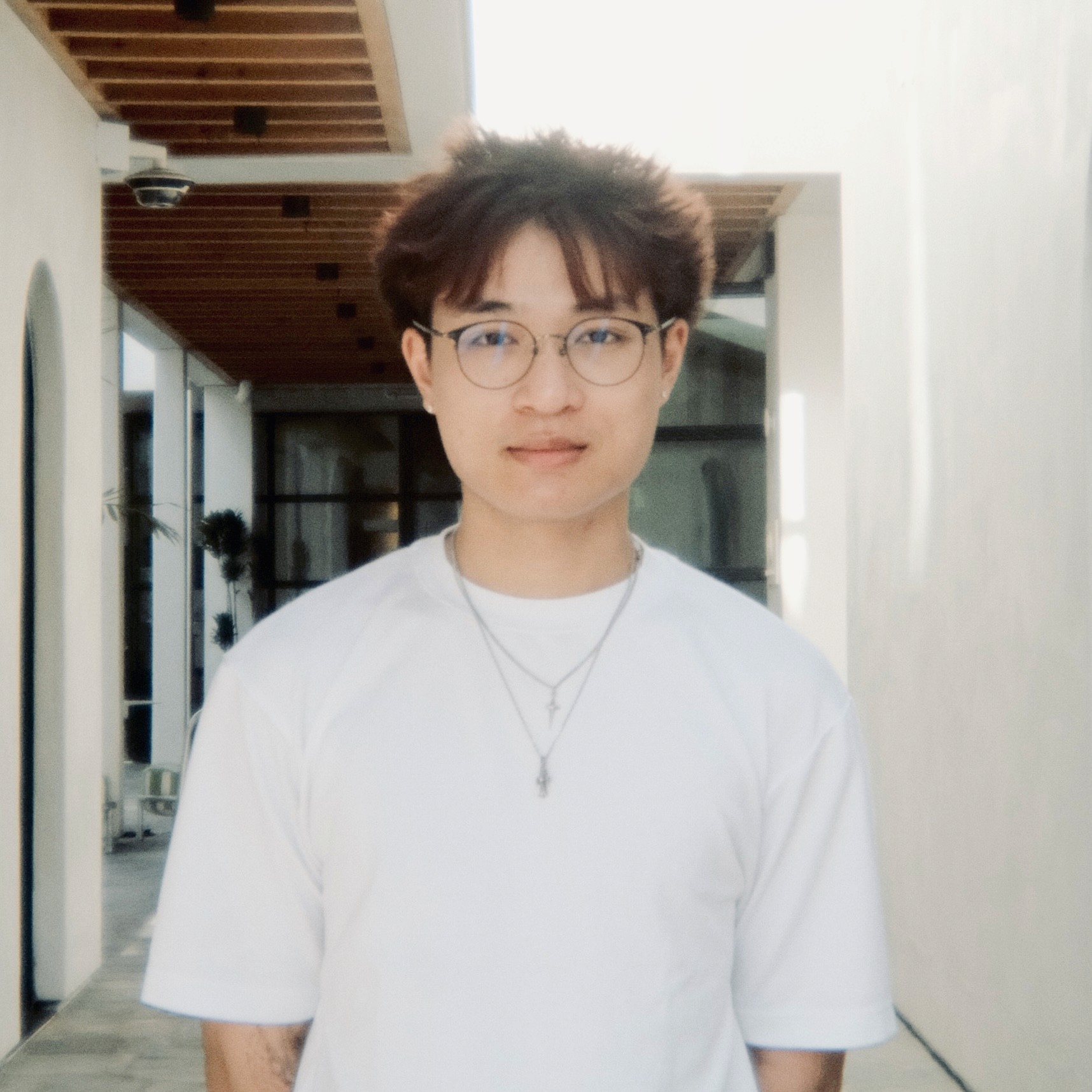 A thoughtful young person, captured in soft lighting.