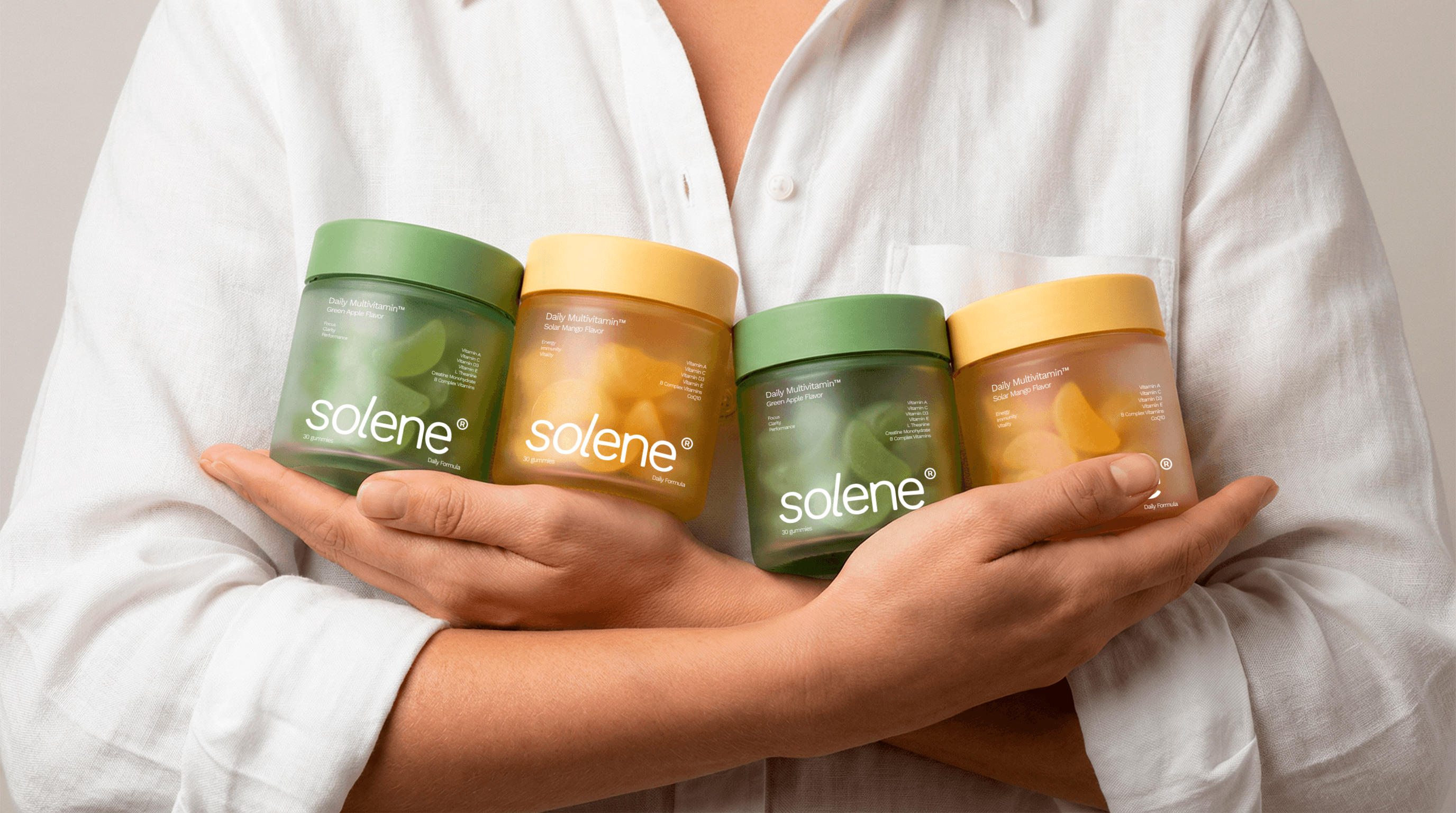 A woman with white blouse hugging jars of gummy