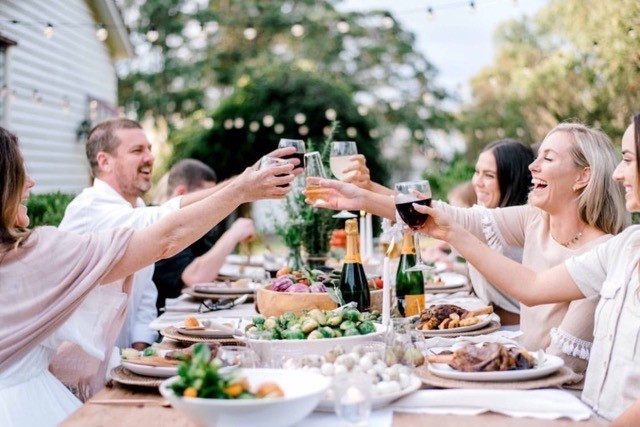 Guests cheering over an outdoor table