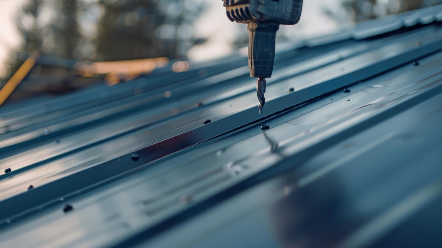 Closeup of an electric drill being used on a metallic roof epitomizing handson labor and craftsmanship in construction