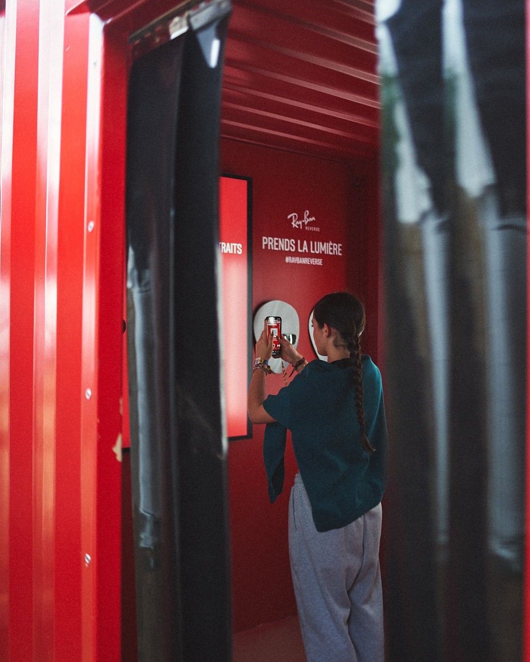 User taking photo inside Ray-Ban photobooth at Les Eurockéennes.
