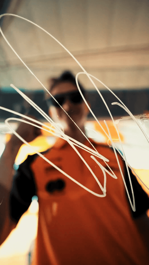 Model walking through a wheat field with a distant gaze.