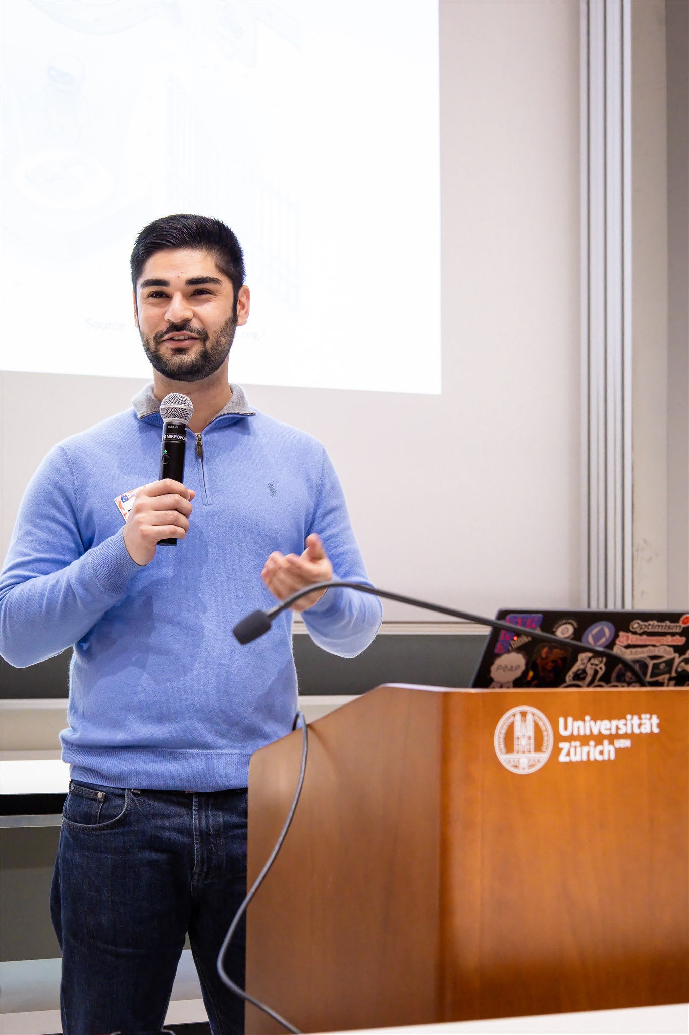 Keynote speaker presenting at podium during EthereumZüri conference