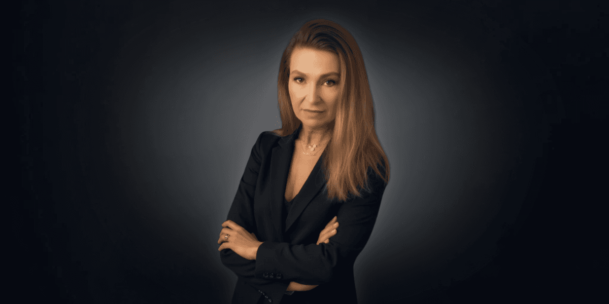 Candi Keffeler, a confident woman in a black suit, exudes strength and empowerment, inspiring others to reclaim hope.