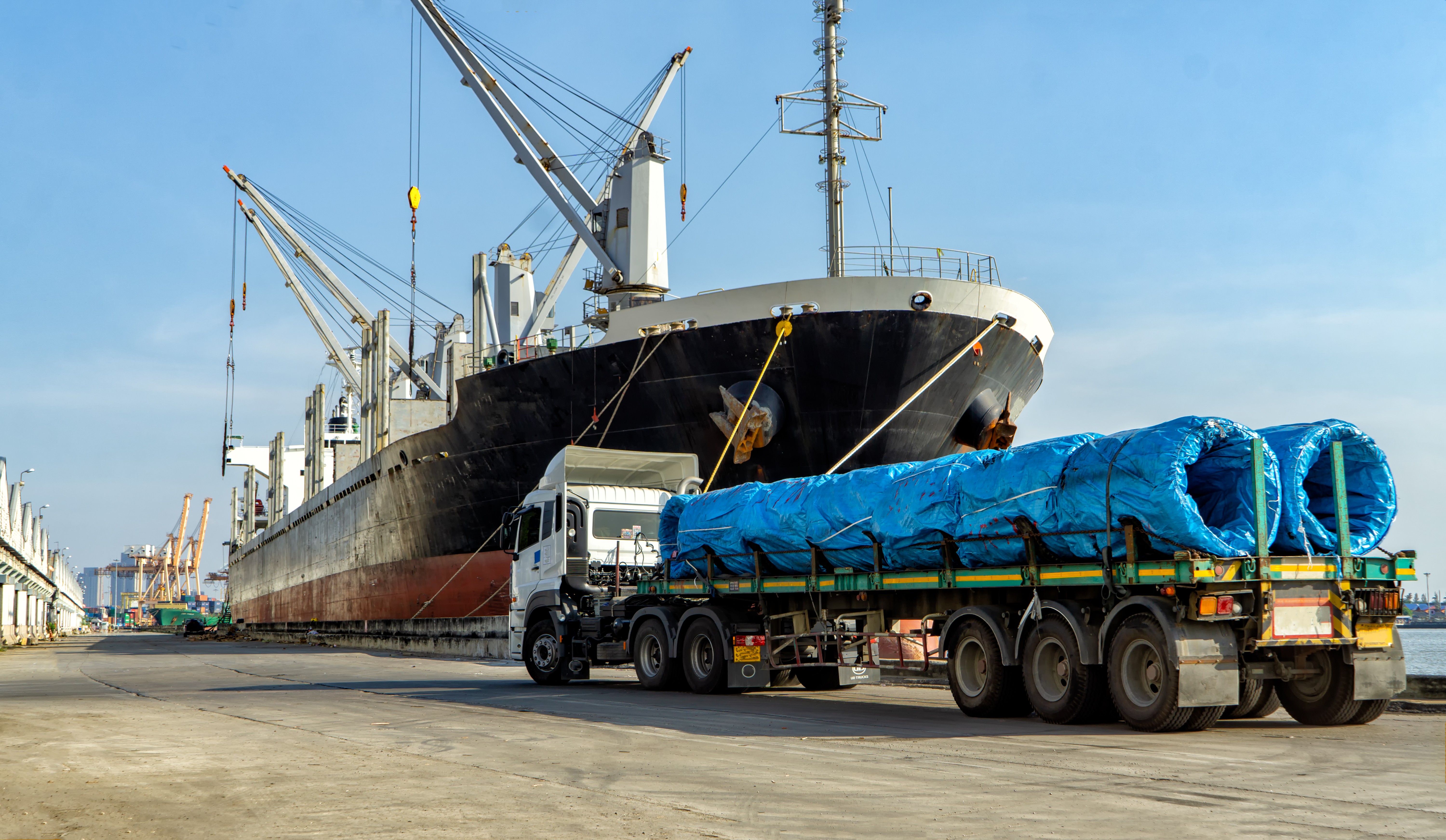 Oversized cargo being brought onto a ship for transport by sea.