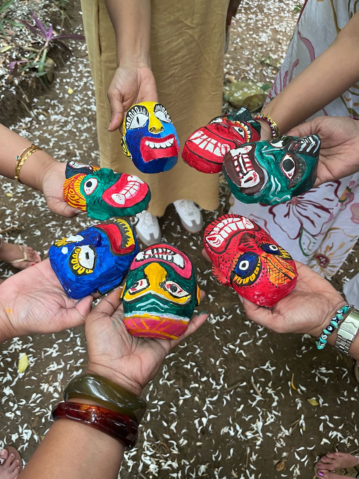 A man playing a drum in front of a group of people