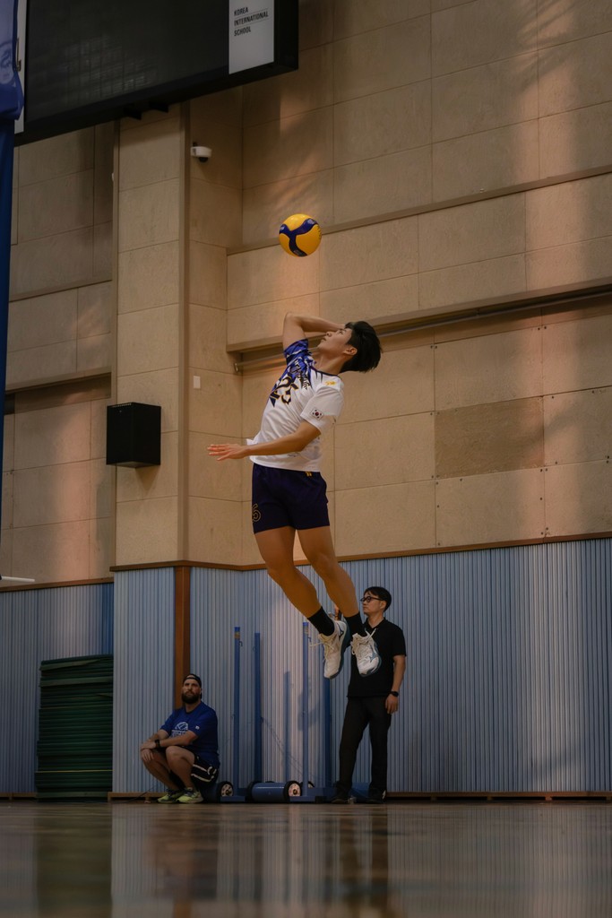A person jumping in the air to catch a ball
