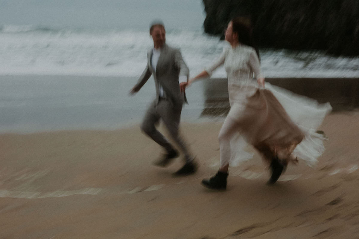 couple eloping wild atlantic way running at beach