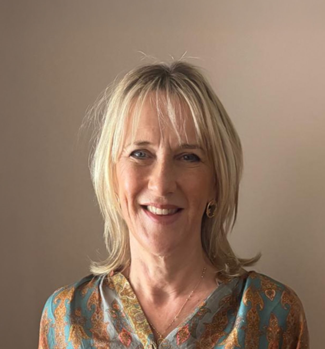 Cartoon girl with brown hair and orange sweater