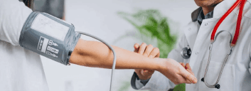 Doctor measuring a patient’s blood pressure.