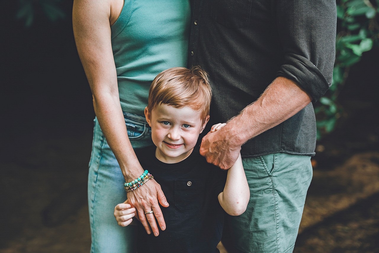 boy leaning against truck for graduation photos