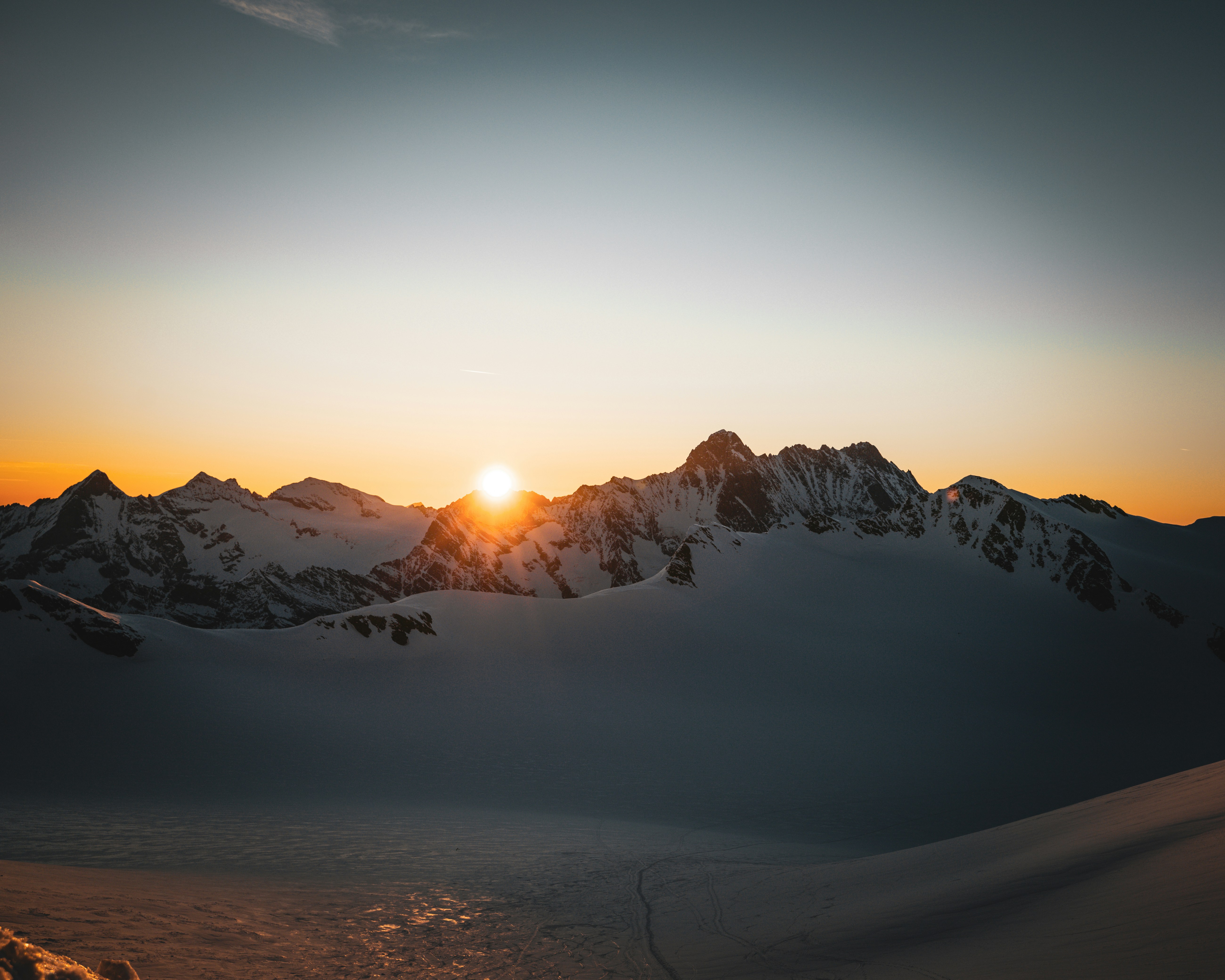 Sunrise over a snow-covered mountain range