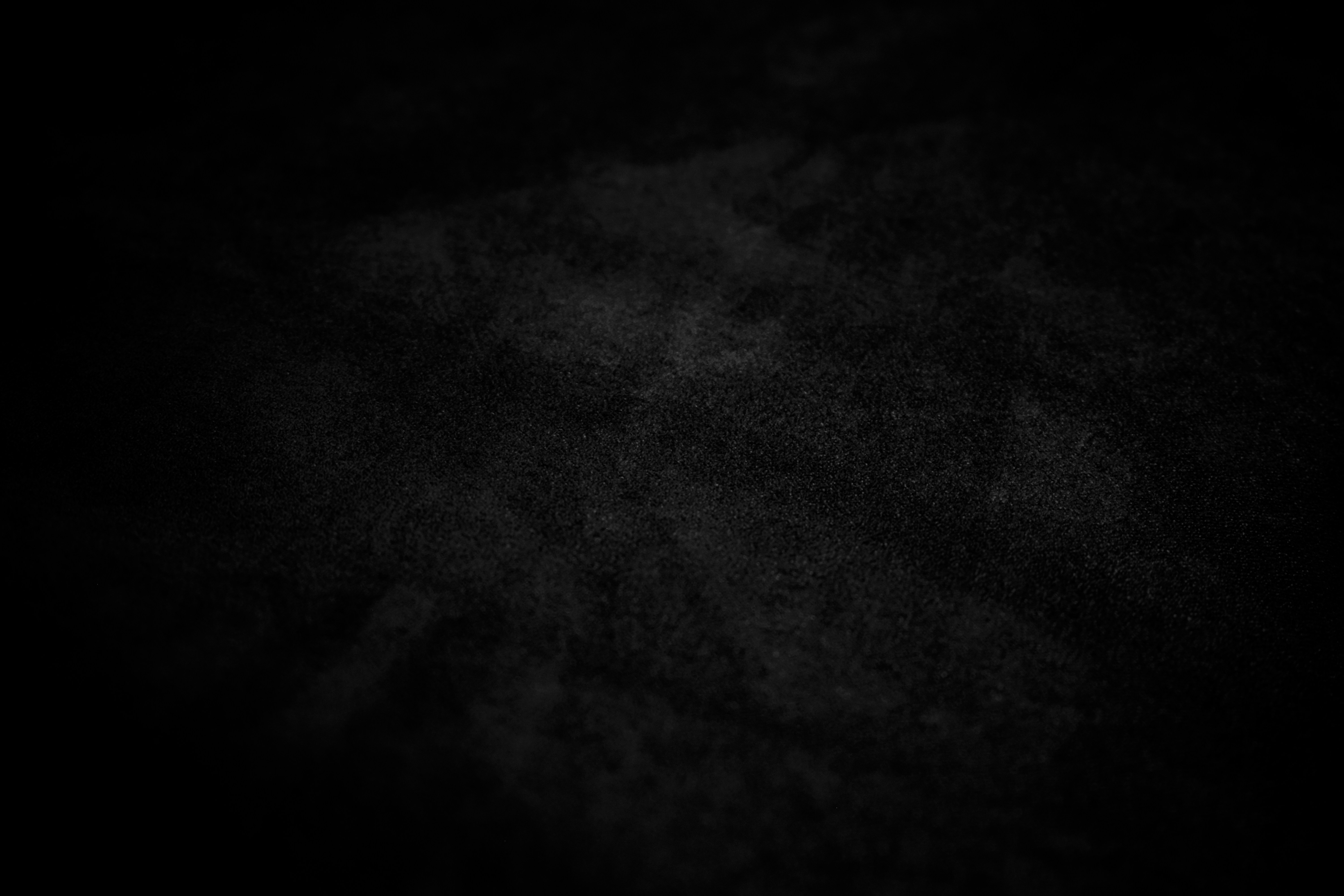 A dark, textured background with subtle light effects.