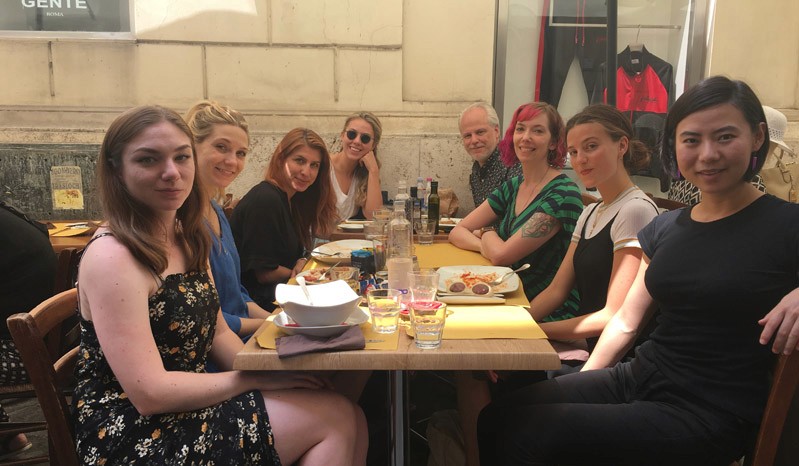 A photo of a group of people sitting at a restaurant table.