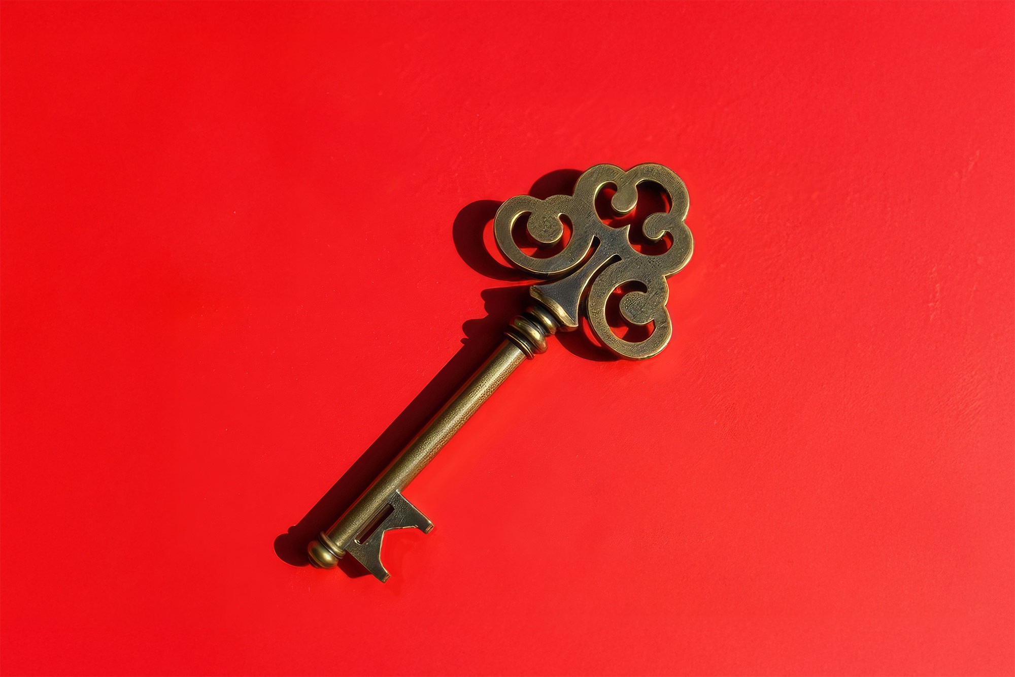 STK brass key on red background