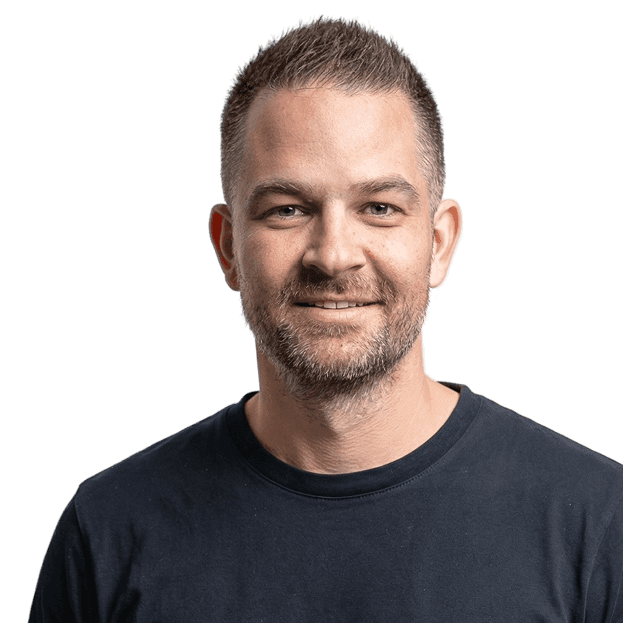 Smiling man with short hair and beard in navy shirt