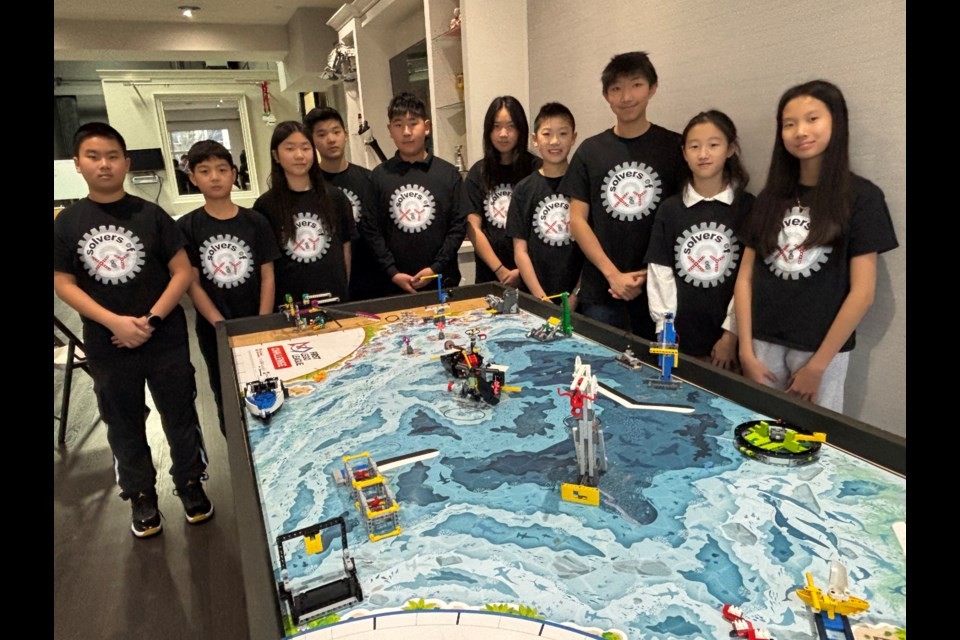 FLL Team Solvers of X & Y around the Submerged Season Robot Mission Mat