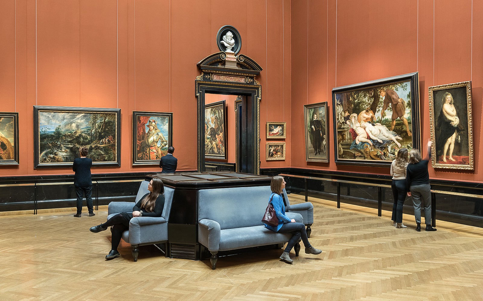 Visitors viewing paintings in a gallery at Kunsthistorisches Museum, Vienna.
