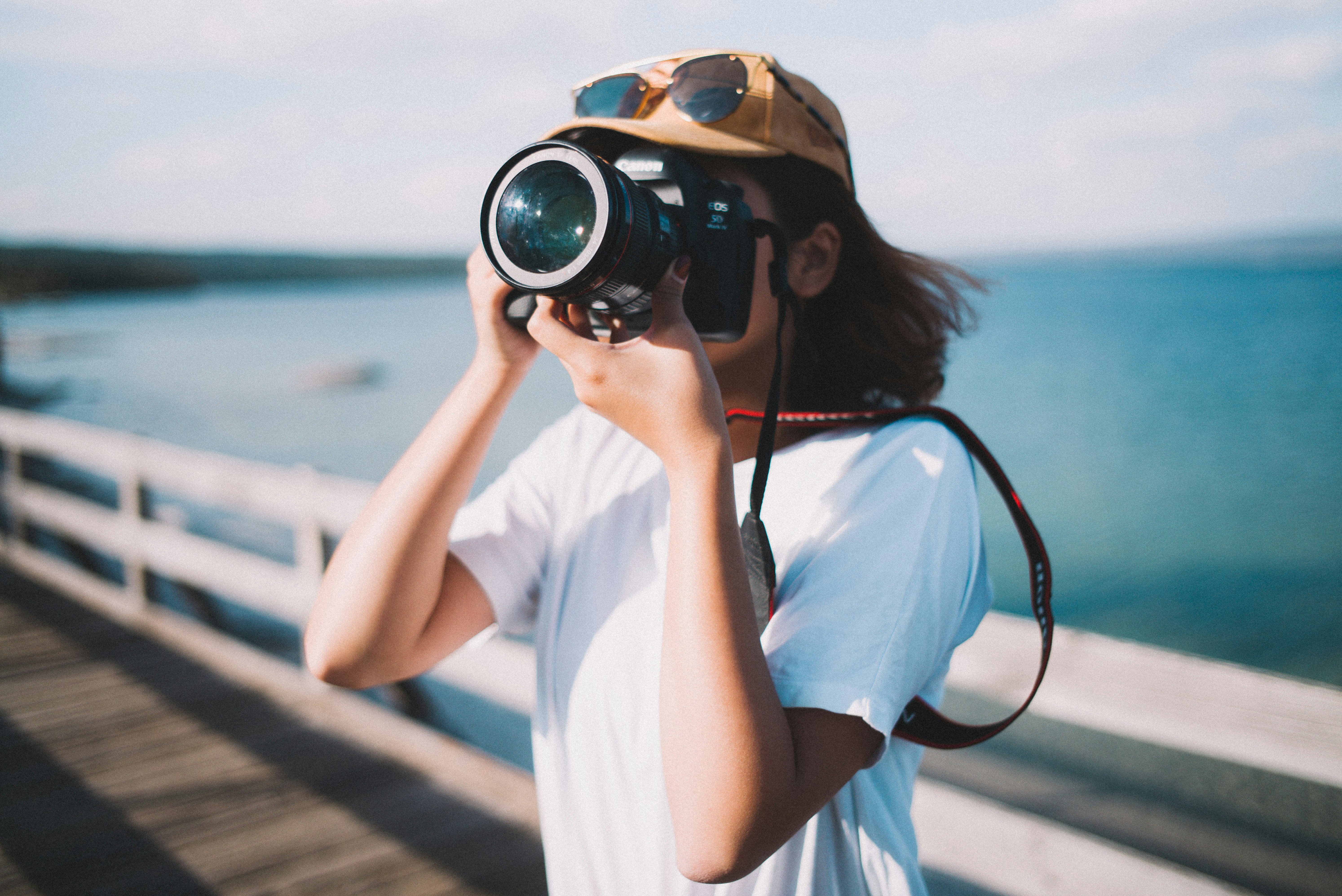 girl shooting photograph near water