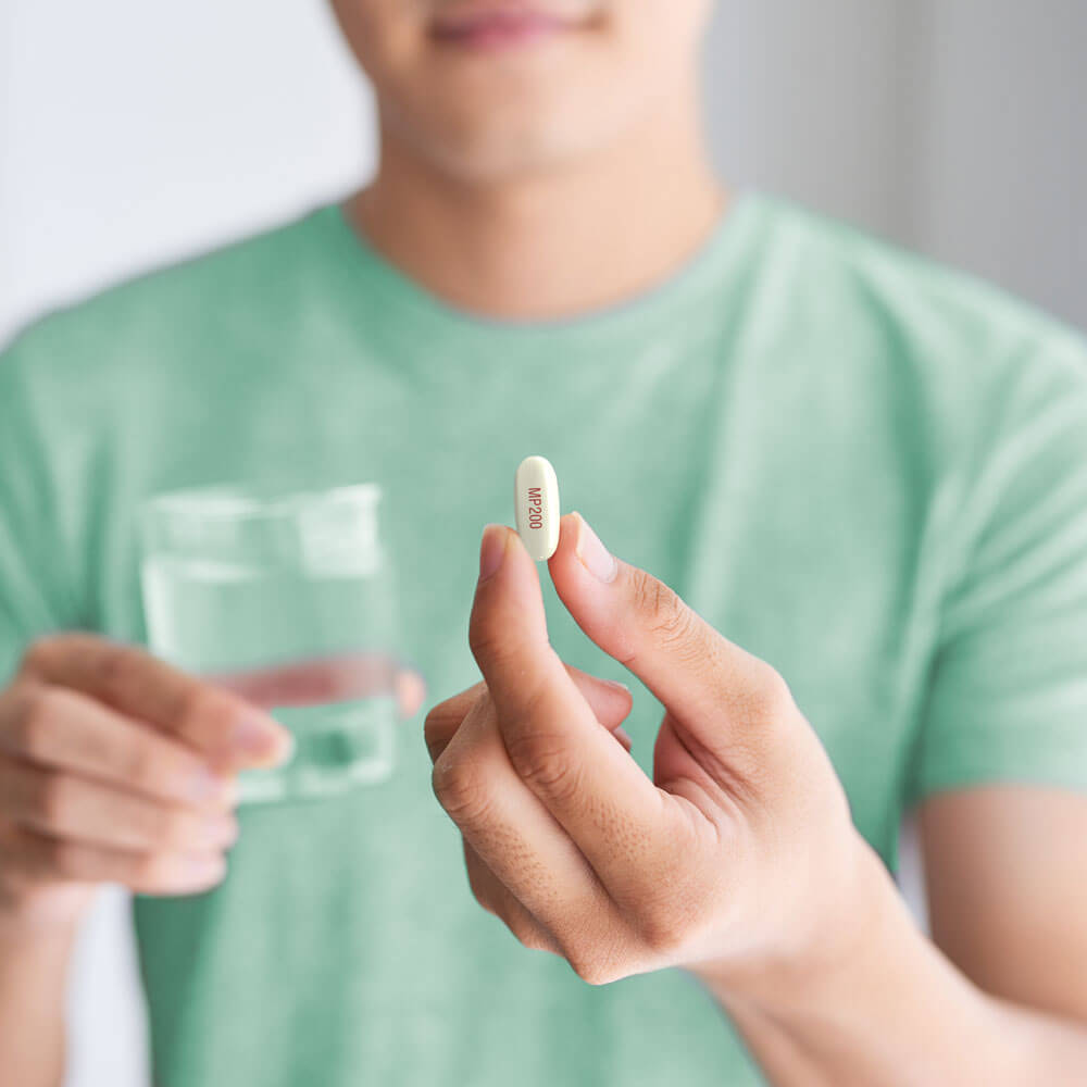 Man holding Kyzatrex pill