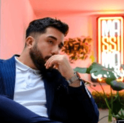 a woman in a black suit and sunglasses