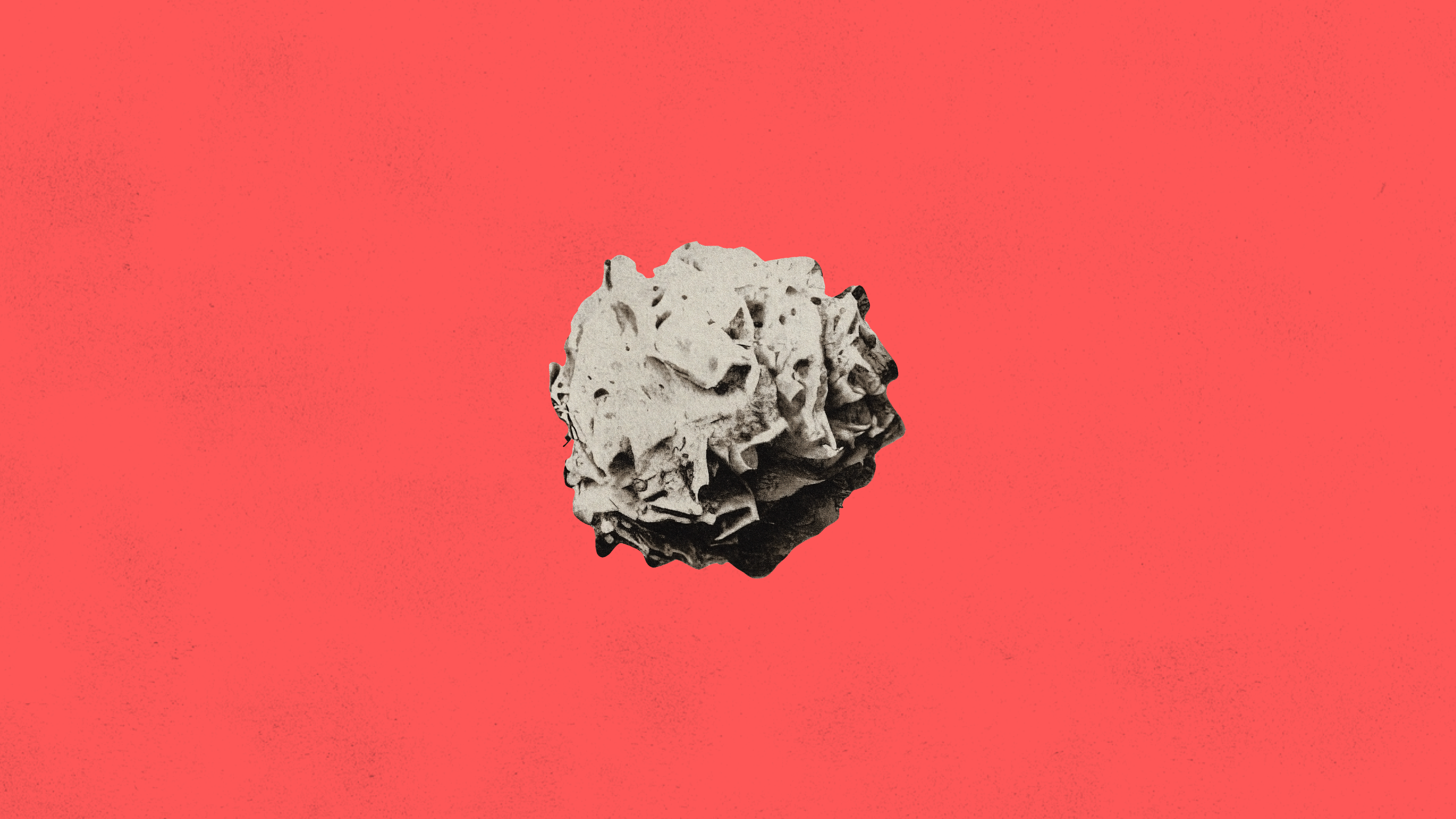 A crumpled gray paper ball centered on a textured red background.