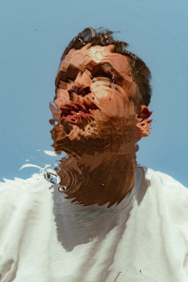 ripple image of mans face underwater