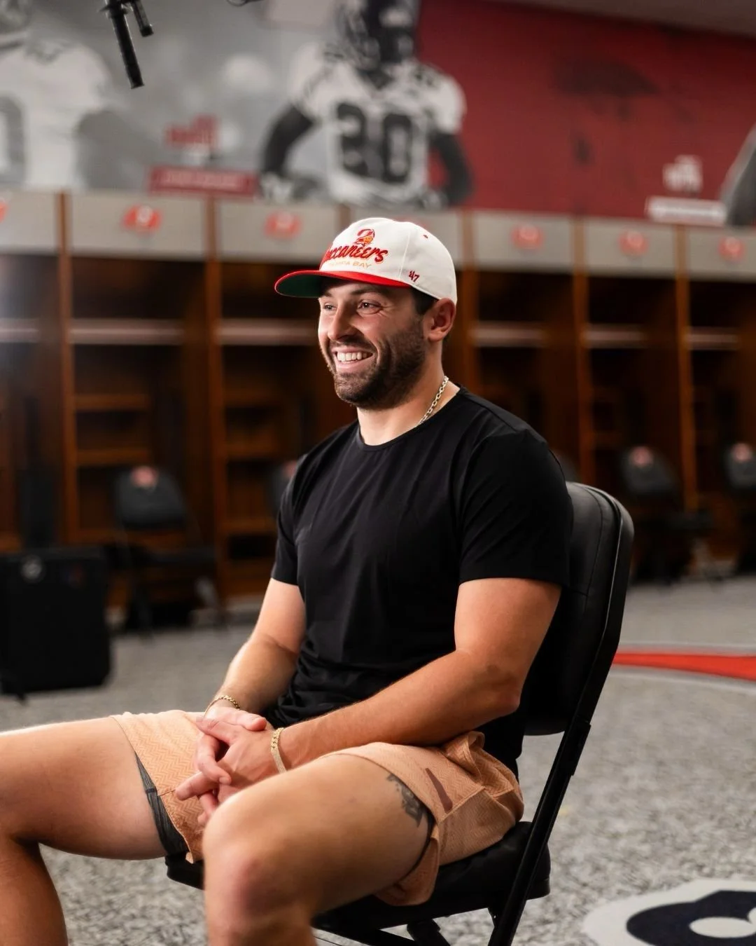 A close-up of a person wearing green-tinted glasses, with a serious expression and smooth skin.