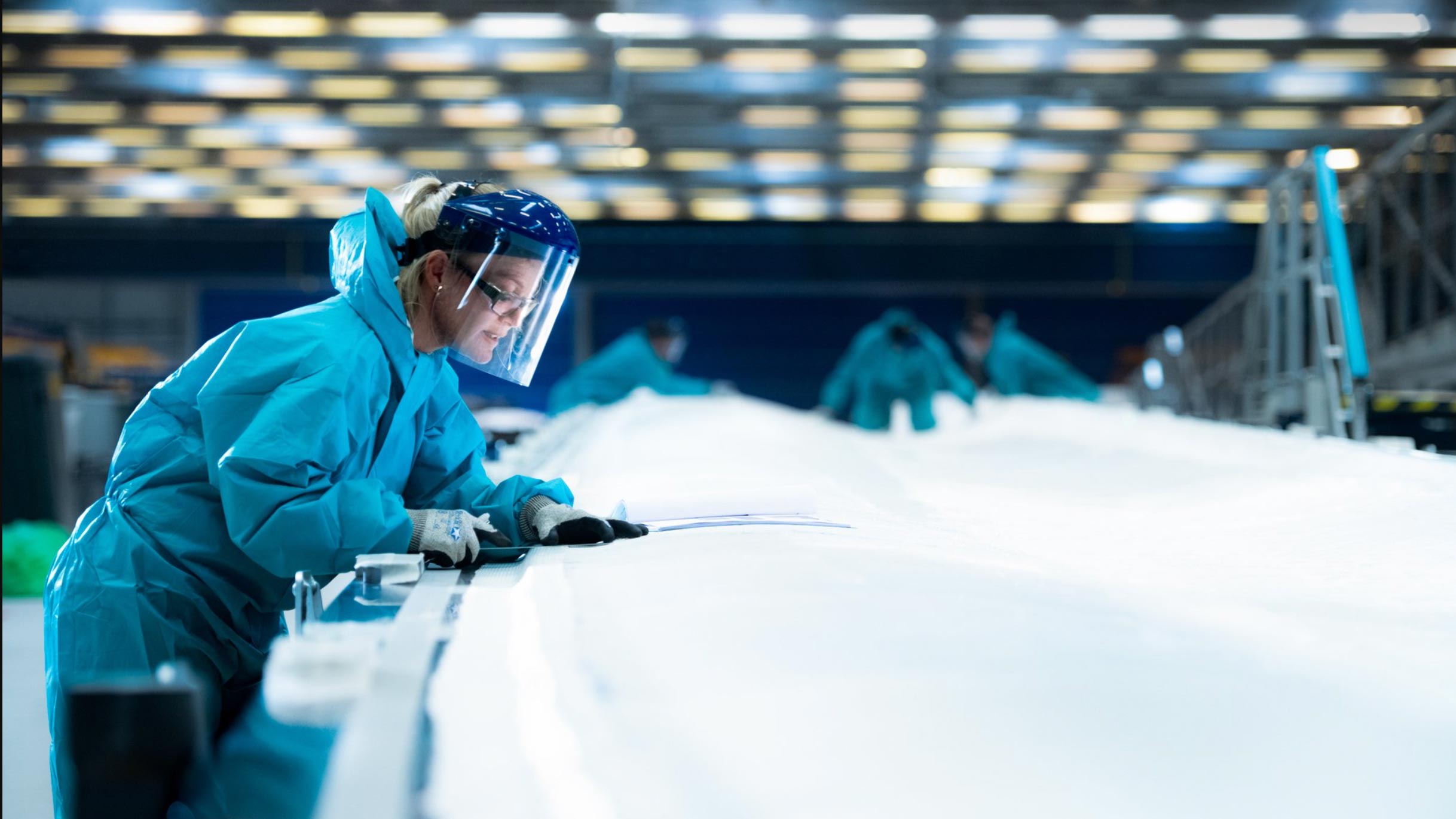 Female worker reviewing blade mould designs