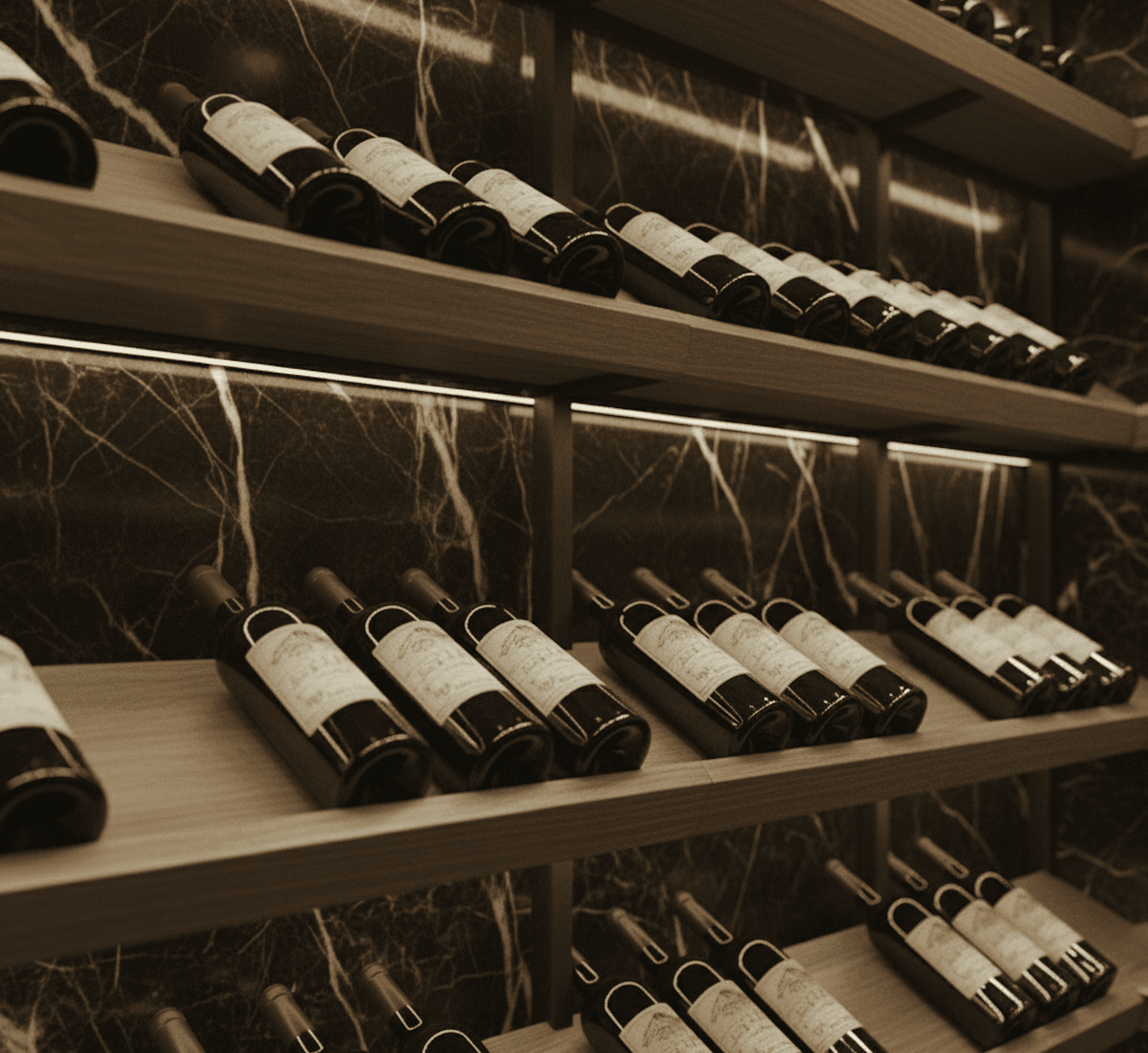 Detail of walnut angled wine shelves with integrated LED lighting set against polished black marble wall in Westlake Modern Noir wine cellar