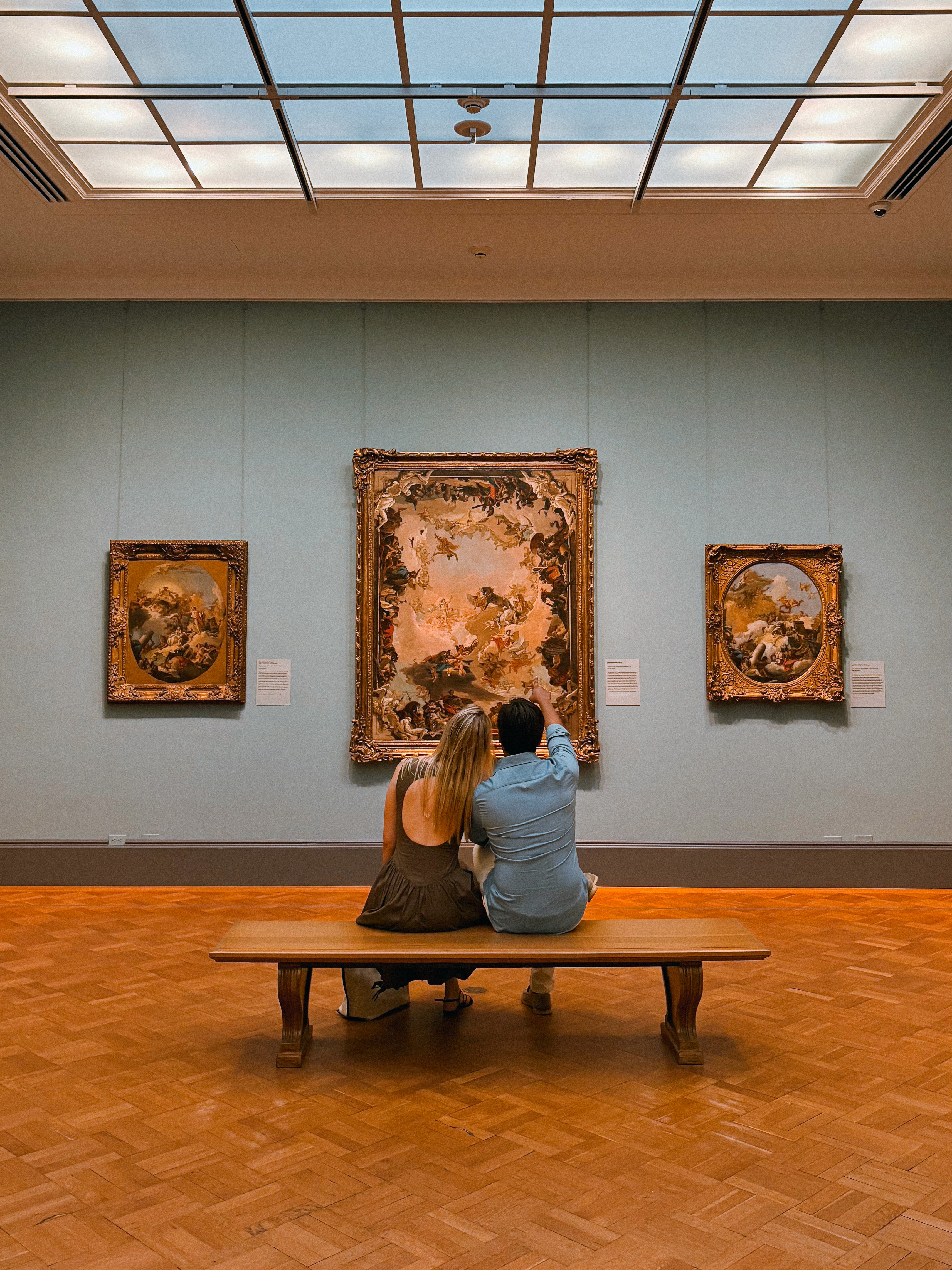 Green car under neon lights in a rainy city street
